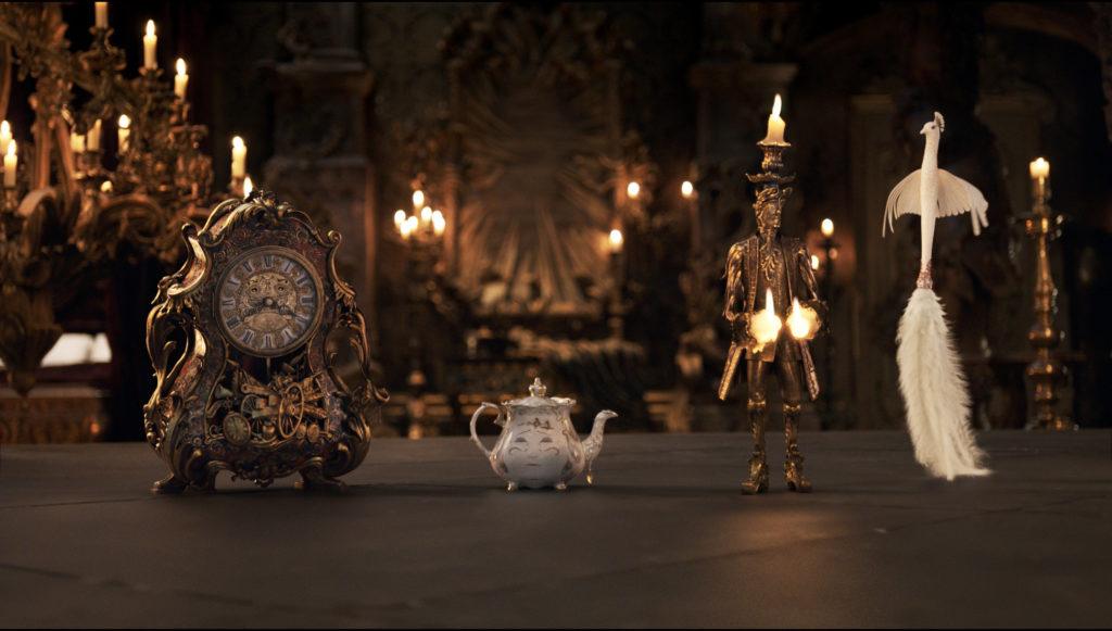 The mantel clock Cogsworth, the teapot Mrs. Potts, Lumiere the candelabra and the feather duster Plumette live in an enchanted castle in Disney's BEAUTY AND THE BEAST the live-action adaptation of the studio's animated classic directed by Bill Condon. ? Disney