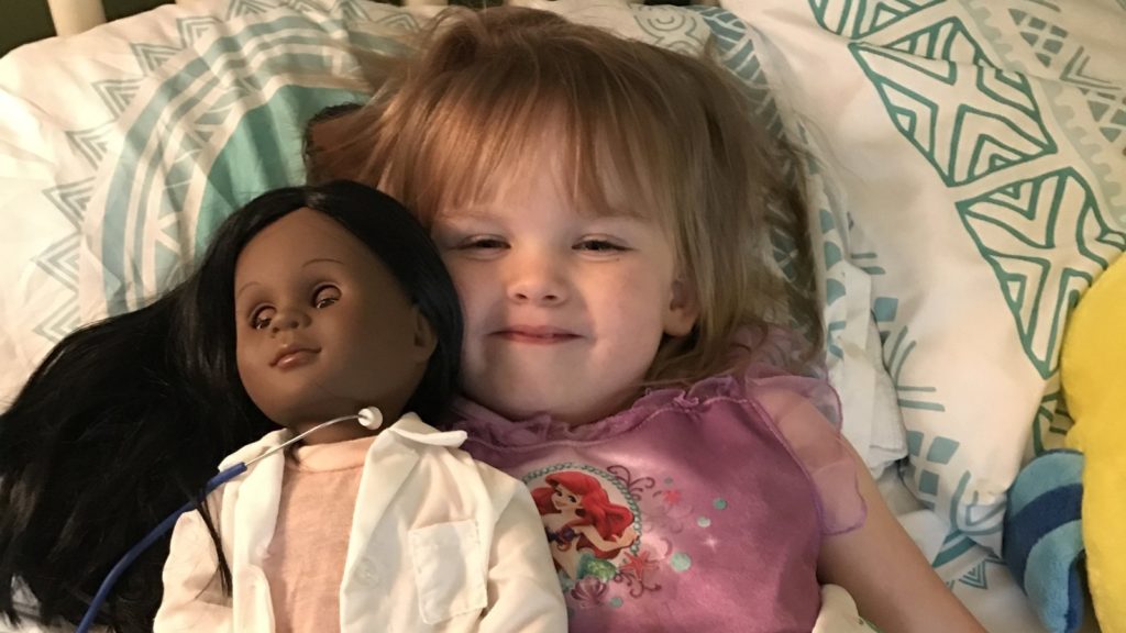 Black doll, white child