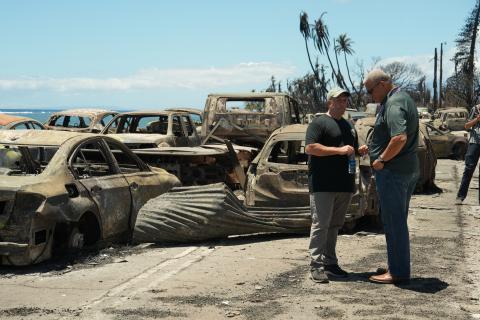 WAILUKU, Hawaii -- Hawaii Gov. Josh Green (left) speaks with an emergency response official about the ongoing response to the Hawaii wildfires and partnership with federal agencies. (FEMA photo)